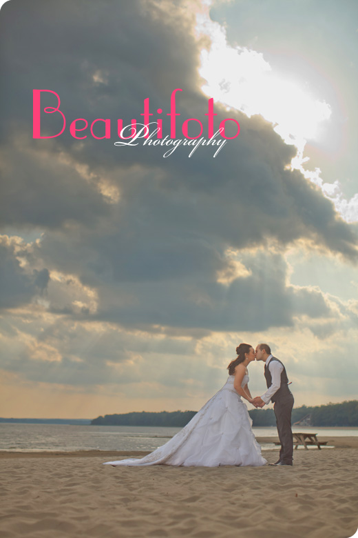 Bride and groom kissing on the beach