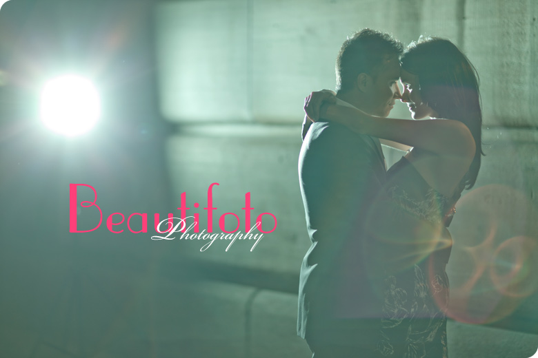 The bride and groom kissing at the old port during their engagement photo session.