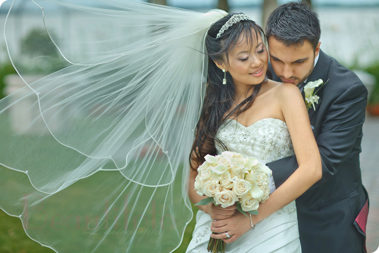 Bride posing with her bouquet in natural light. Photographer: Beautifoto