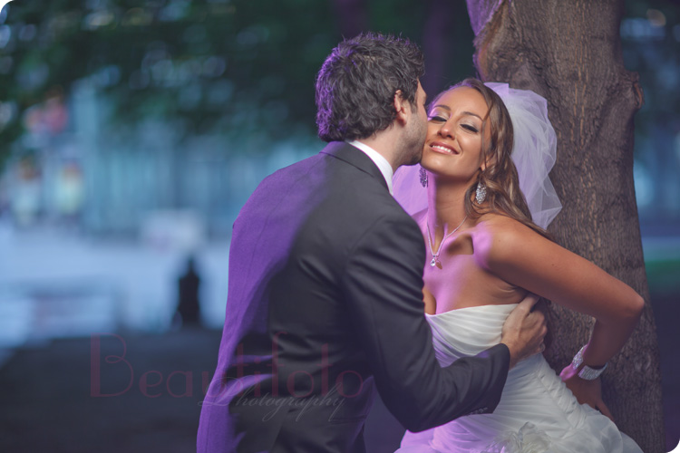 Groom kissing a bride on the cheek at the Old Port of Montreal