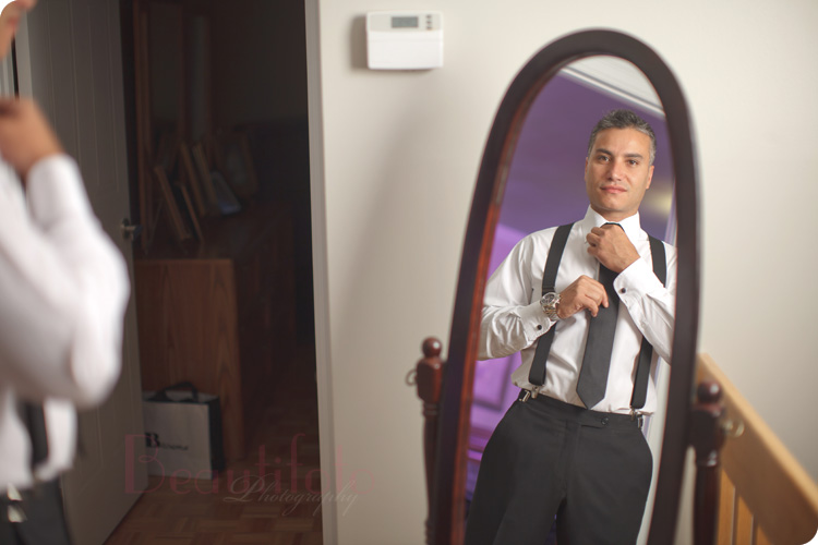 The groom getting ready before heading out to the church. Photo by Beautifoto