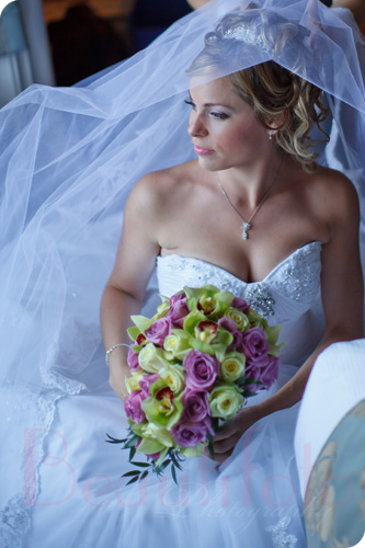 the bride getting her veil adjusted by her mom