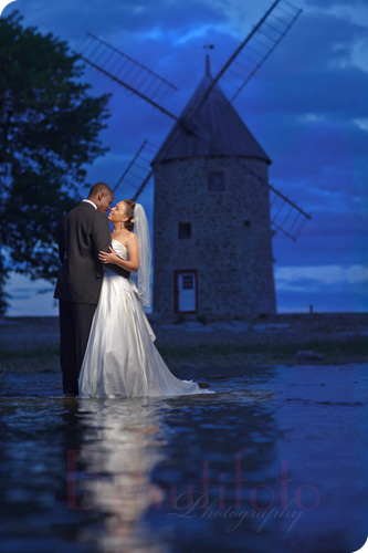 the bride and groom romantic shot by a windmill in Montreal