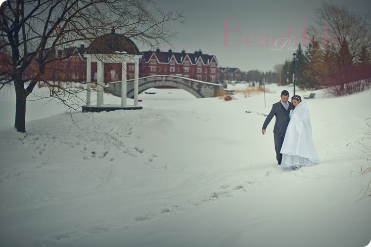 an artistic shot of the bride and groom walking in the snow on their winter wedding day