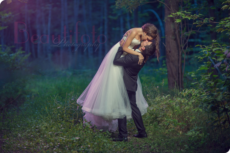 the bride and groom in a fairytale forest setting, a photo by Beautifoto