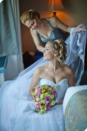 the bride getting her veil adjusted by her mom